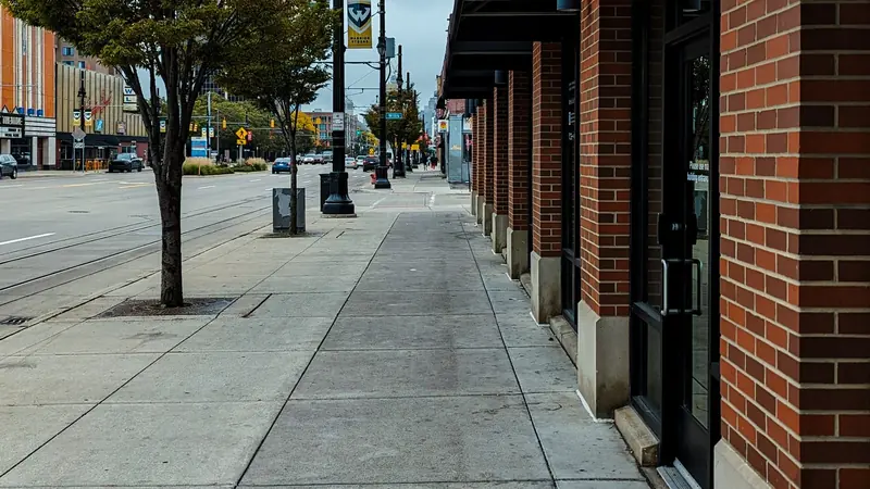 Brick storefronts on a small-town sidewalk (example photo)