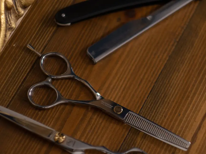 Barber scissors on a wooden counter (example photo)