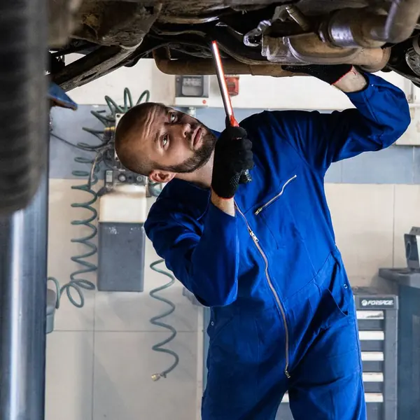 Technician under a car on the lift (example photo)